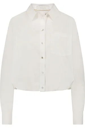 NUKUS De Ariana Blouse van is een minimalistische dames blouse met een opstaande kraag, lange mouwen en een cropped fit