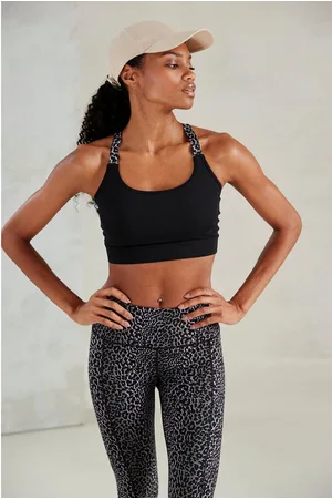 Lascana Crop-top -Sporttop Sporttop met gekruiste bandjes in leeuwprint